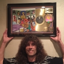 Co-Owner and Chief Mastering Engineer Mike Wilson in front of the SoSo Def Bass Allstars gold selling plaque located in the Studio B Hallway.